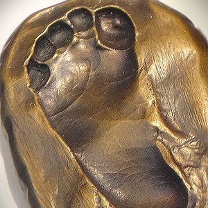 In Metall gegossener Fußabdruck eines Kindes